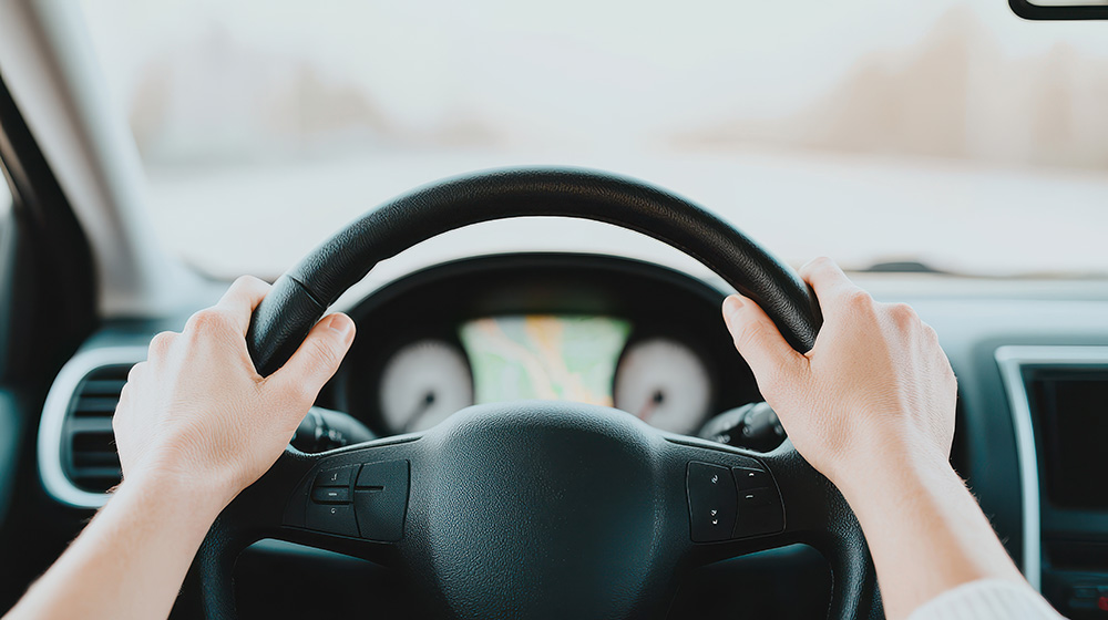 Hands showing how to hold the steering wheel.